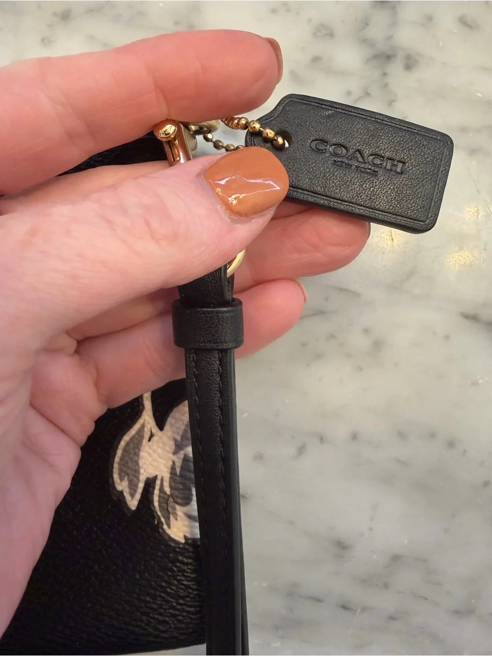 COACH Black Floral Zip Wristlet with Gold Logo